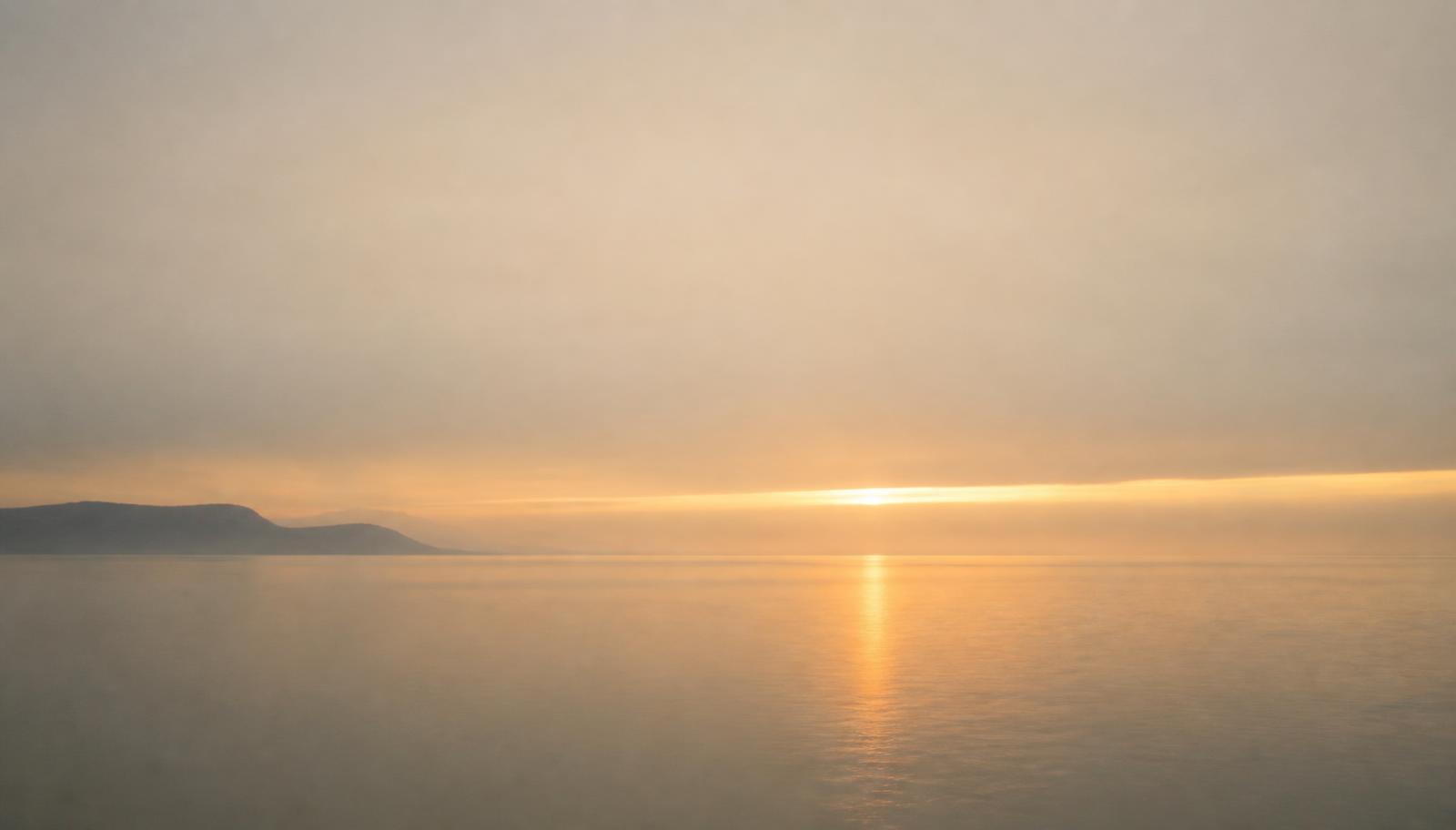 Horizonte tranquilo ao amanhecer sobre águas calmas